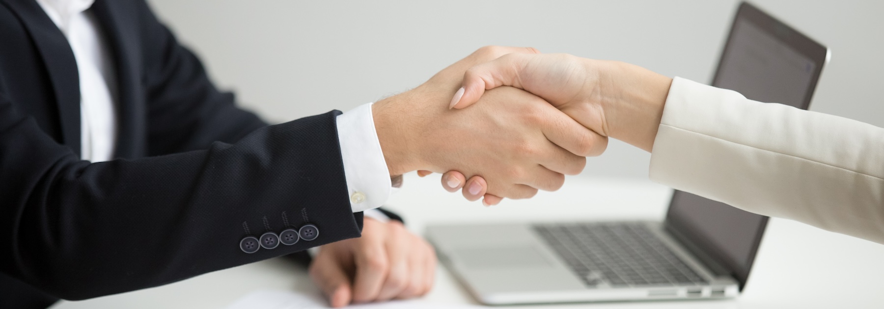 Employment handshake concept, female hr and successful woman candidate shaking hands getting hired ready to sign job contract concept, employer congratulating welcoming new worker, close up view